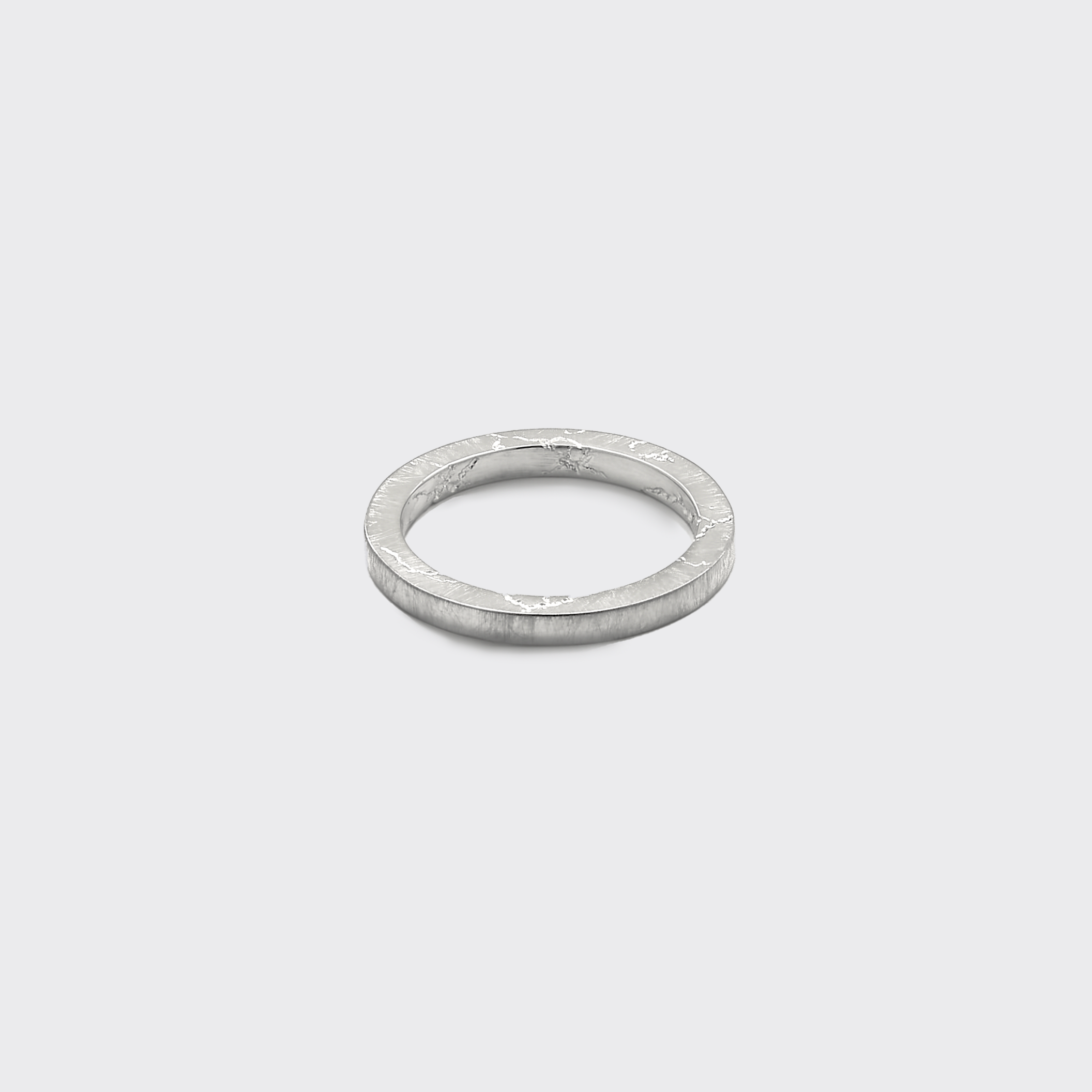 Silver ring on a light gray background