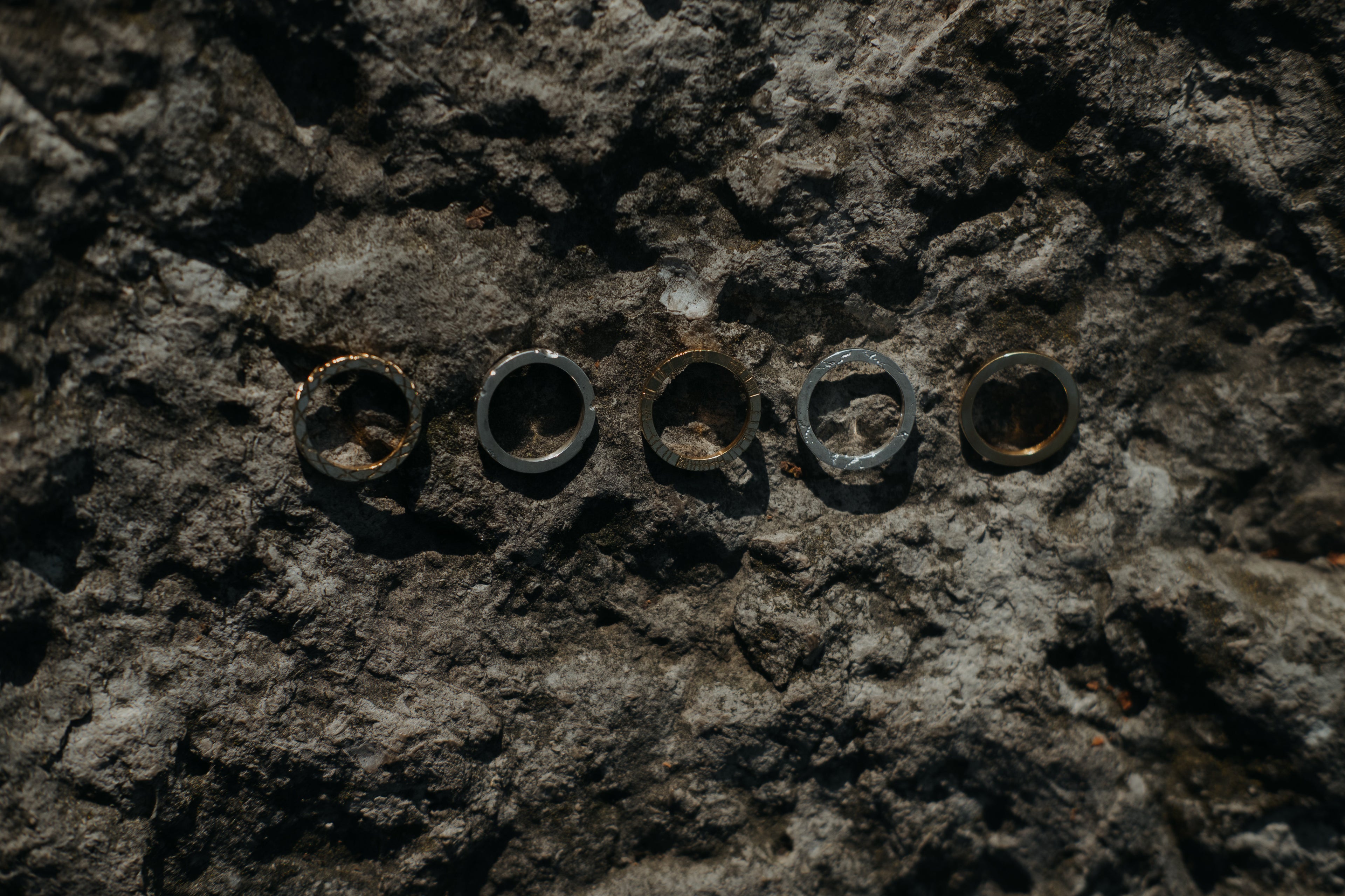 Close-up of rings on a textured stone surface