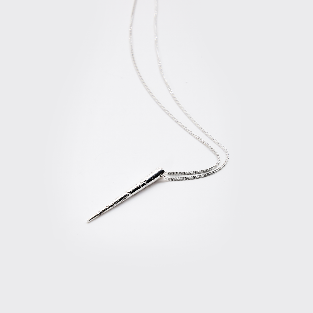 Silver necklace with a unique pendant on a white background